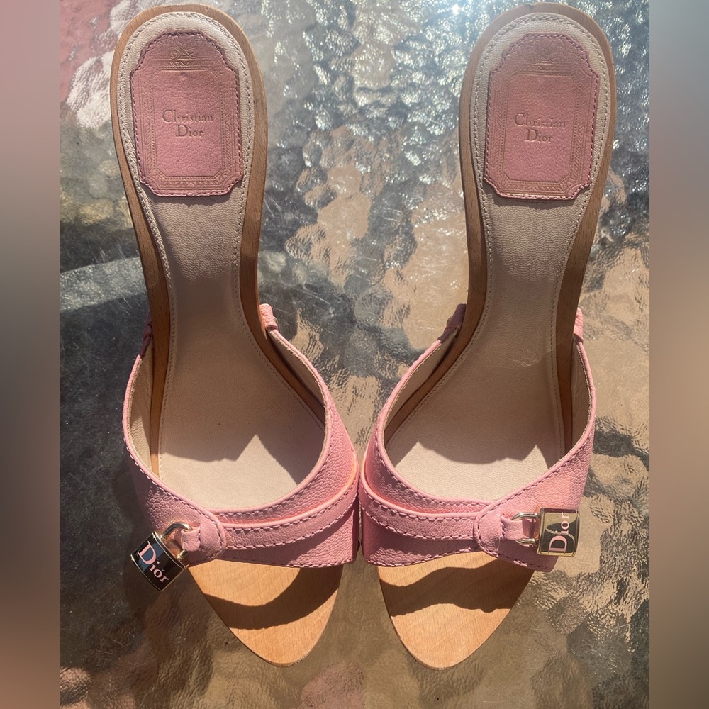 Pink leather with a wooden sole and gold charm.